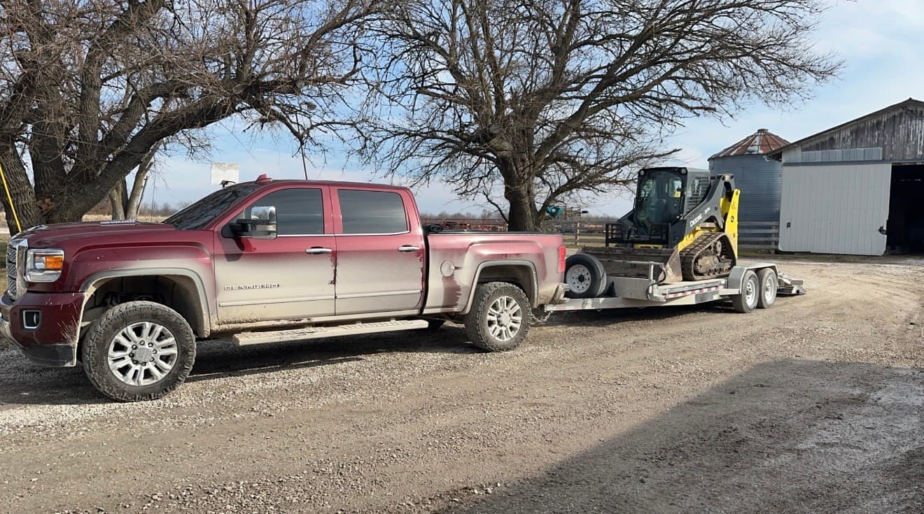 Gruenloh Equipment delivering a skid steer on trailer to a job site in Randolph County, Missouri