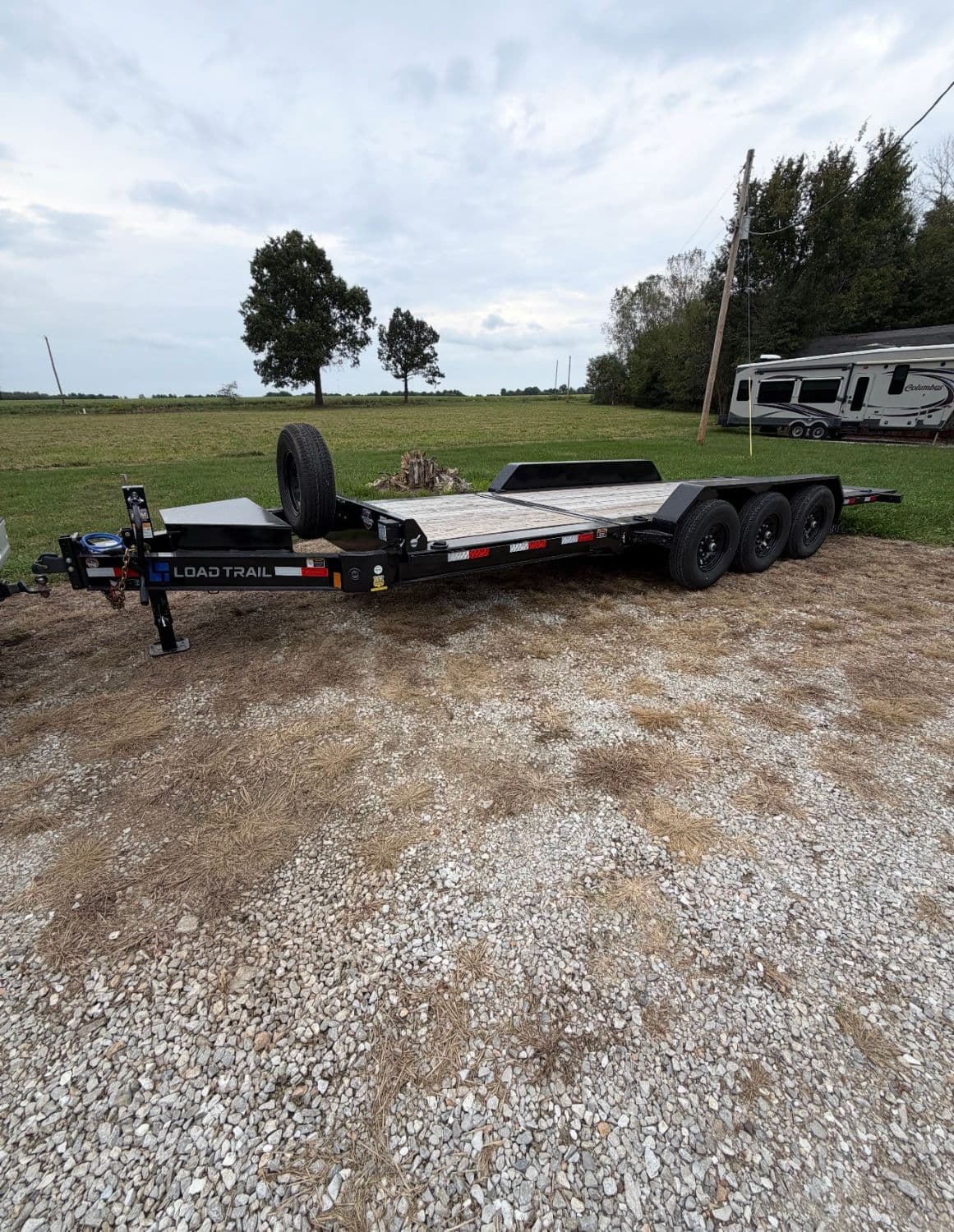 Load Trail triple-axle tilt deck equipment trailer for rental in Randolph County, Missouri